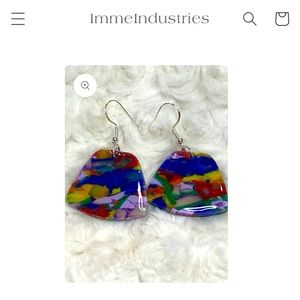 Hand made polymer clay earrings finished with resin. Striking silver hook